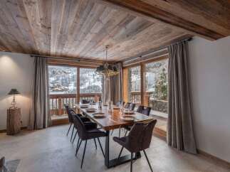 This dining area features a solid wood table perfect for gathering with loved ones.