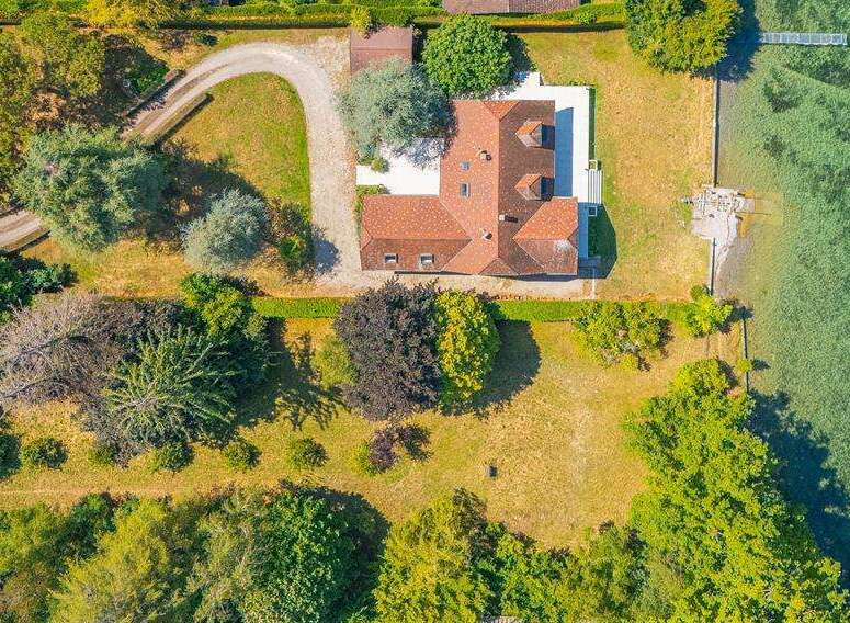 This aerial view showcases a stunning waterfront property with a private pier, offering direct access to the water.