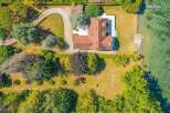 This aerial view showcases a stunning waterfront property with a private pier, offering direct access to the water.