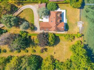 This aerial view showcases a stunning waterfront property with a private pier, offering direct access to the water.