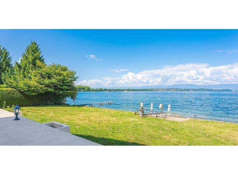 Discover a stunning waterfront property with breathtaking views of the expansive lake and clear blue skies.