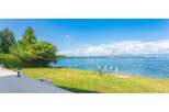 Discover a stunning waterfront property with breathtaking views of the expansive lake and clear blue skies.