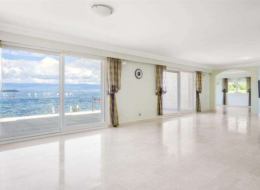 Expansive living area with floor-to-ceiling windows offering breathtaking waterfront views.
