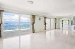 Expansive living area with floor-to-ceiling windows offering breathtaking waterfront views.