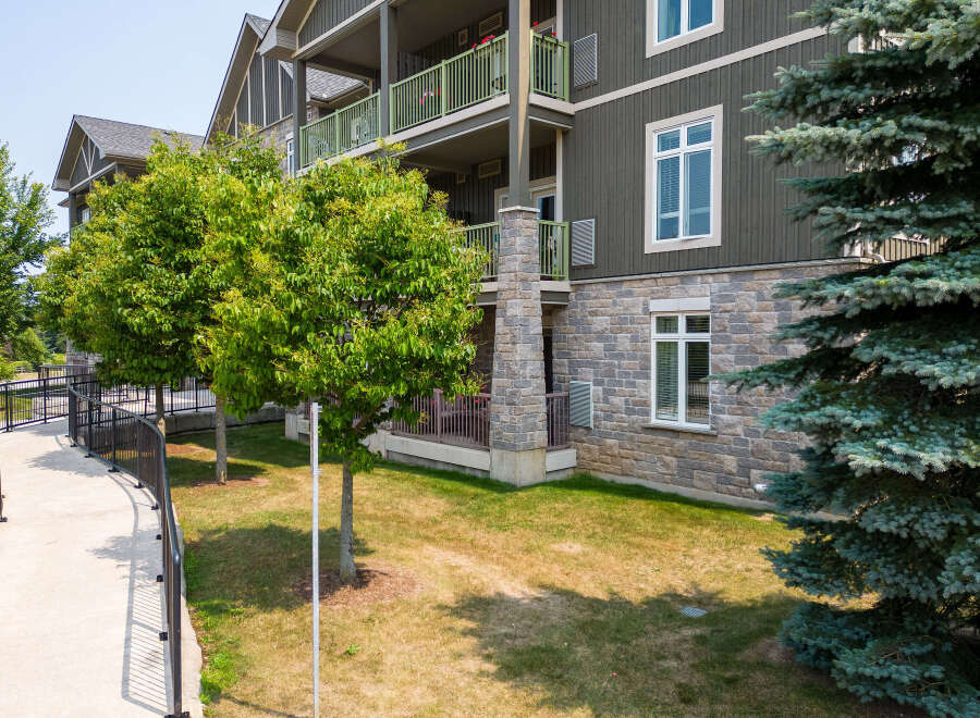 Discover upscale living in this multi-story apartment complex with beautiful stone accents and inviting green balconies.