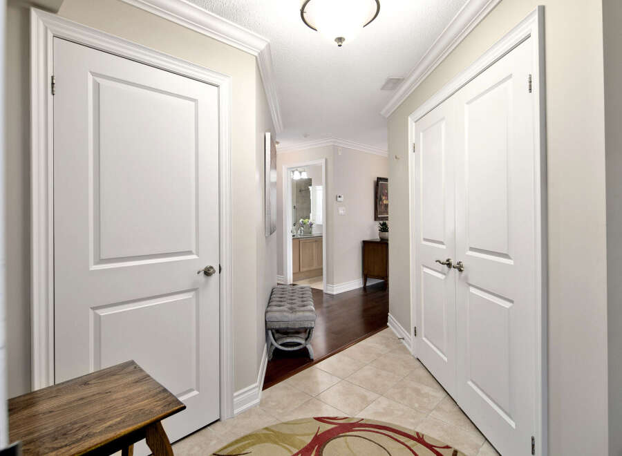 This inviting hallway features classic white doors that offer privacy to various rooms.