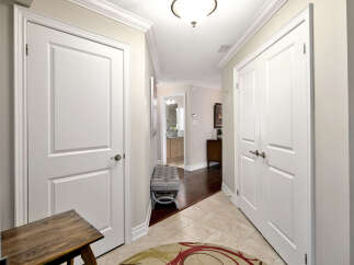 This inviting hallway features classic white doors that offer privacy to various rooms.