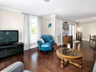 Step into this inviting living space featuring rich hardwood floors that amplify the natural light.