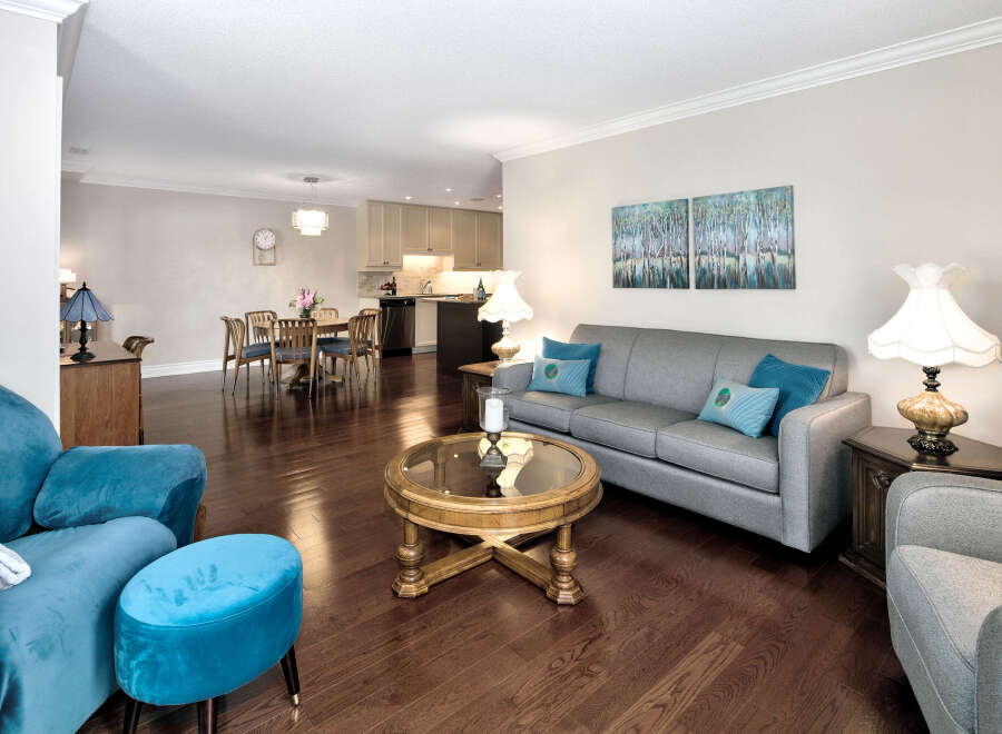 Step into this inviting living space, featuring rich hardwood floors that complement the neutral walls.