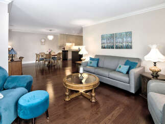 Step into this inviting living space, featuring rich hardwood floors that complement the neutral walls.
