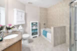 This bathroom features a tiled shower and bathtub combination, creating a spa-like retreat.