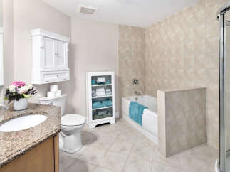 This bathroom features a tiled shower and bathtub combination, creating a spa-like retreat.