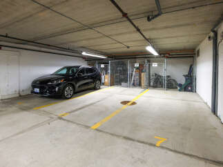 This parking spot is in a well-lit, secured garage, offering convenience and safety for residents.