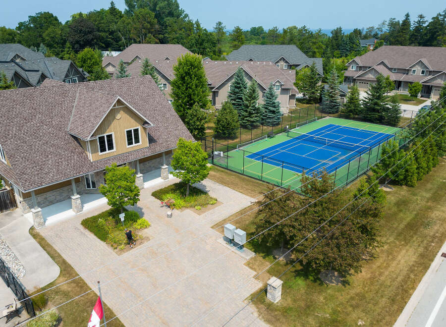 Discover luxury living in this stunning property featuring a private tennis court and meticulously landscaped grounds.