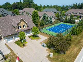 Discover luxury living in this stunning property featuring a private tennis court and meticulously landscaped grounds.