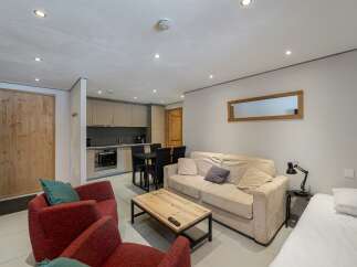 Discover this cozy apartment featuring a well-equipped kitchen, perfect for preparing meals.