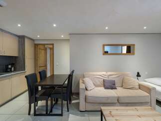 Discover this cozy apartment featuring a well-equipped kitchen, perfect for preparing meals.
