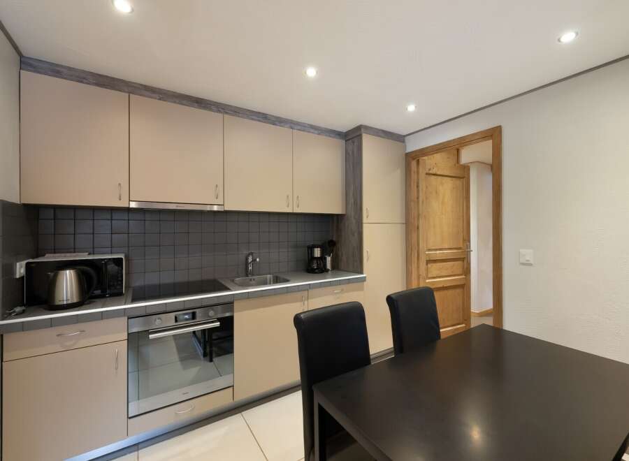 This charming kitchen features modern appliances and ample cabinet space, perfect for preparing delicious meals.