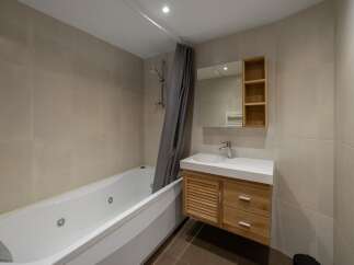This modern bathroom features a luxurious jacuzzi tub, perfect for relaxation.