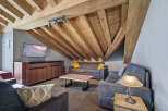 Discover the charm of this stunning property, featuring a cozy living room with a unique wooden ceiling.