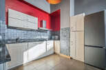 This modern kitchen boasts sleek cabinetry and a stainless steel refrigerator, perfect for culinary enthusiasts.