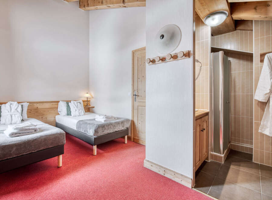 Experience comfort and style in this inviting bedroom, featuring two cozy beds perfect for a relaxing stay.
