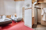 Experience comfort and style in this inviting bedroom, featuring two cozy beds perfect for a relaxing stay.