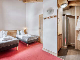 Experience comfort and style in this inviting bedroom, featuring two cozy beds perfect for a relaxing stay.