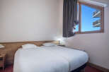 This cozy bedroom features two twin beds, perfect for guests or roommates.