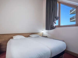 This cozy bedroom features two twin beds, perfect for guests or roommates.