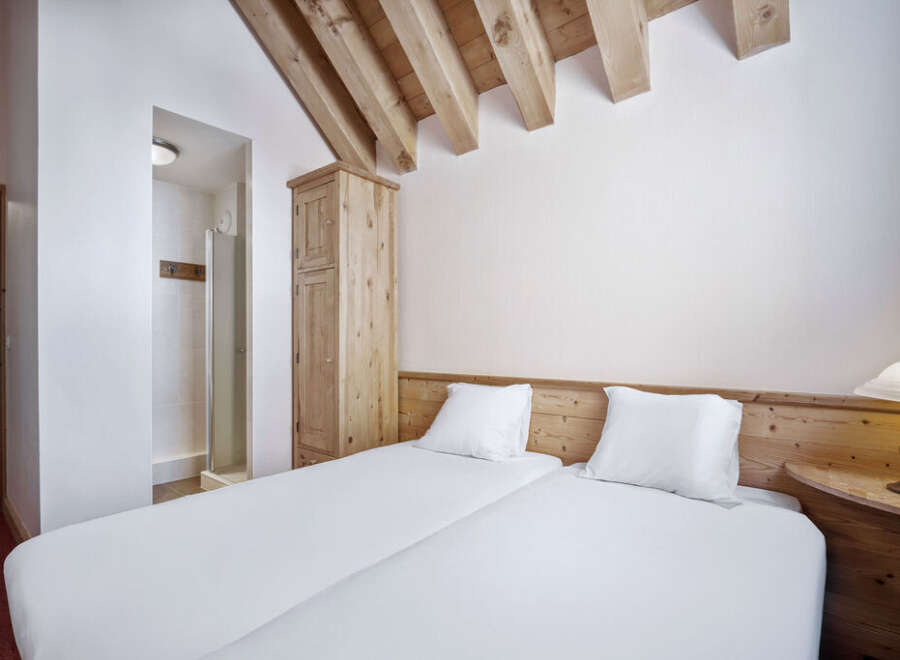 This cozy bedroom features two twin beds, perfect for guests or roommates.