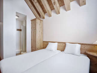 This cozy bedroom features two twin beds, perfect for guests or roommates.
