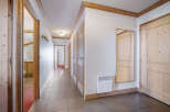 Step into this inviting hallway, showcasing a warm and rustic aesthetic with its wooden doors and trim.