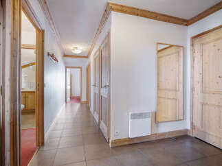 Step into this inviting hallway, showcasing a warm and rustic aesthetic with its wooden doors and trim.