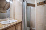 This charming bathroom features a rustic wooden vanity and a sleek, modern sink.