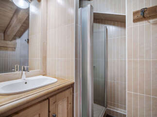 This charming bathroom features a rustic wooden vanity and a sleek, modern sink.