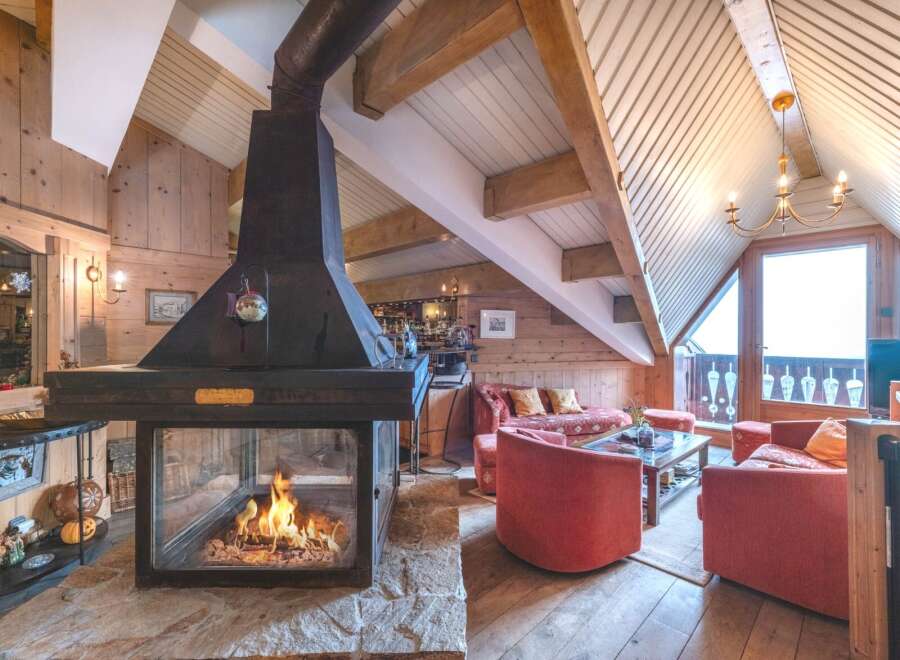 Experience the warmth of this stunning chalet with a cozy fireplace, perfect for those chilly evenings.