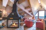 Experience the warmth of this stunning chalet with a cozy fireplace, perfect for those chilly evenings.