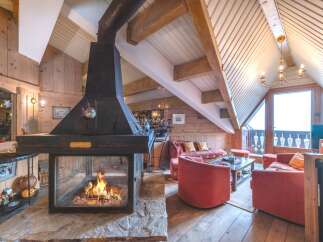 Experience the warmth of this stunning chalet with a cozy fireplace, perfect for those chilly evenings.