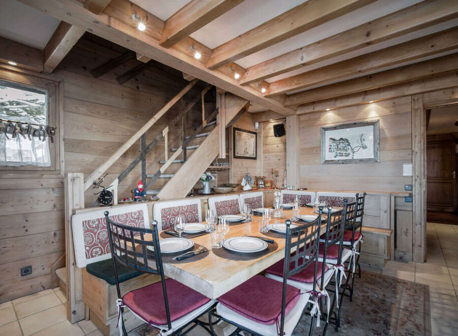 This charming dining area features a rustic wooden design, creating a warm and inviting atmosphere.