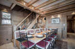 This charming dining area features a rustic wooden design, creating a warm and inviting atmosphere.