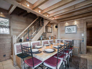 This charming dining area features a rustic wooden design, creating a warm and inviting atmosphere.