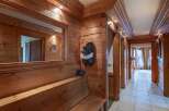 Step into this inviting hallway, showcasing warm wooden paneling and a built-in bench.