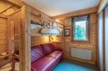 This cozy room features a unique bunk bed design with charming wooden accents, perfect for a family getaway.