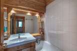 Step into a charming bathroom featuring rustic wooden accents and a bright, inviting atmosphere.