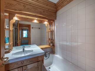 Step into a charming bathroom featuring rustic wooden accents and a bright, inviting atmosphere.