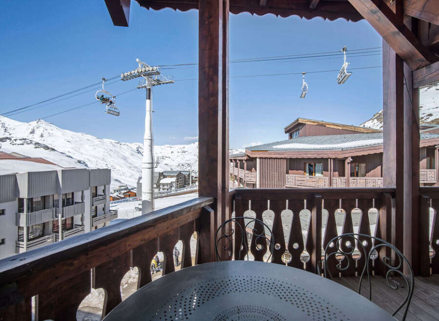 Enjoy breathtaking mountain views from this charming ski chalet balcony.