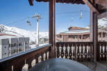 Enjoy breathtaking mountain views from this charming ski chalet balcony.