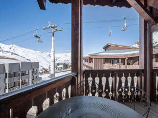 Enjoy breathtaking mountain views from this charming ski chalet balcony.
