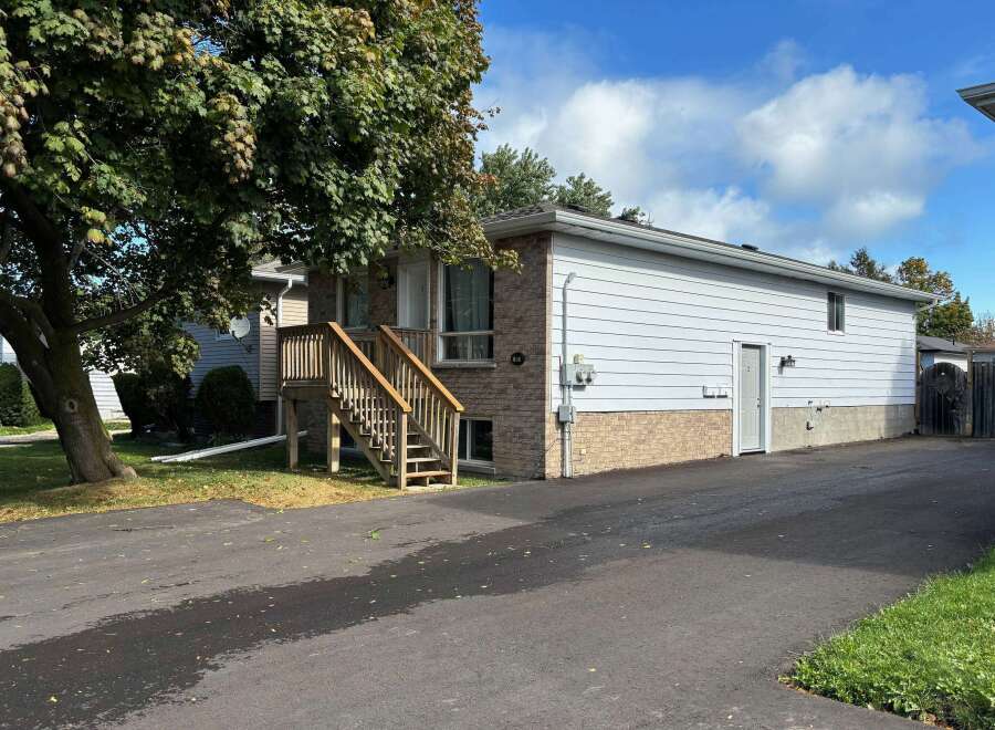 Charming home with a welcoming wooden staircase leading to the front door.